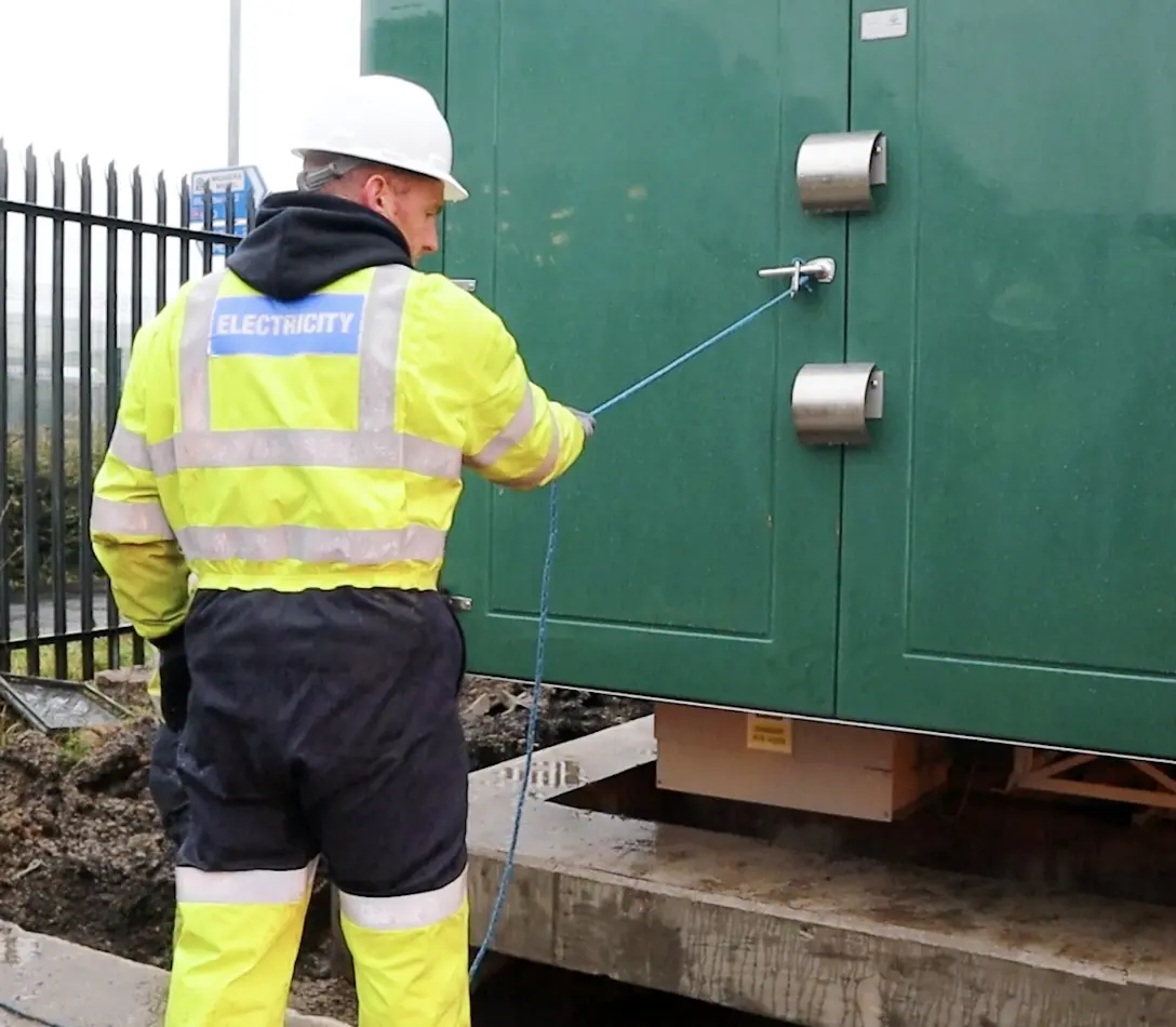 Worker installing a substation
